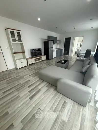 Spacious modern living room with open kitchen and stylish furniture in a bright apartment.