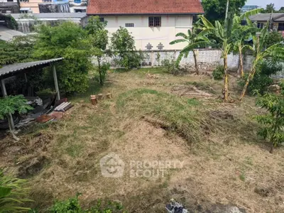 Spacious residential plot with lush greenery and potential for development.