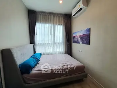 Cozy bedroom with modern decor and large window for natural light