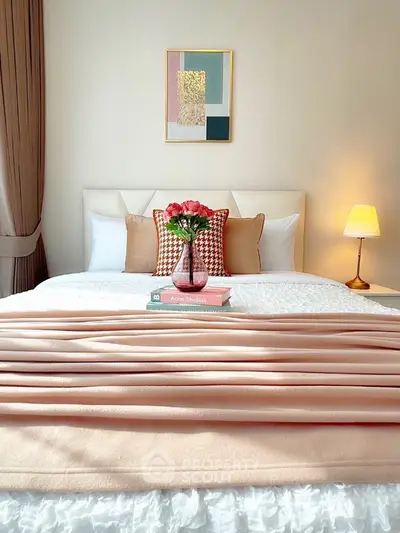 Elegant bedroom with cozy decor and soft lighting, featuring a stylish bed and modern artwork.