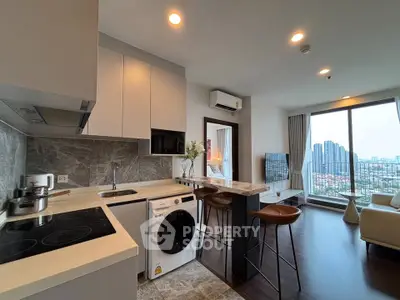 Modern open-plan kitchen and living room with city view in high-rise apartment