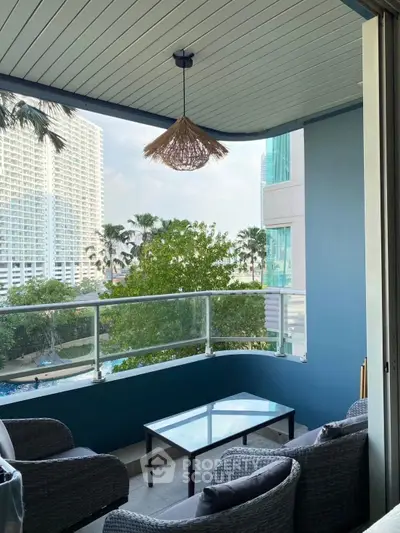 Charming balcony with cozy seating and stunning city view, perfect for relaxation and entertaining.