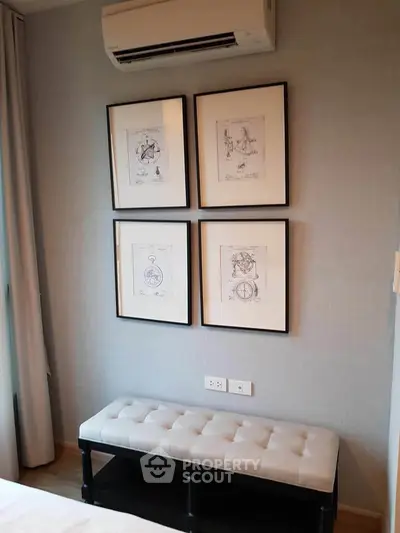 Stylish bedroom corner with framed art and elegant bench seating