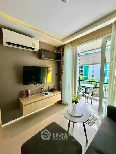 Modern living room with balcony view, featuring sleek furniture and natural light.