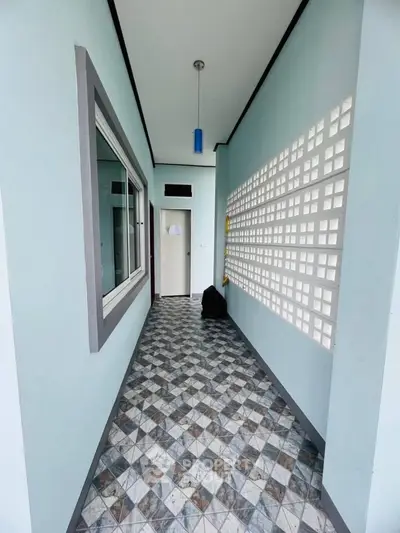 Charming corridor with modern tile flooring and stylish lighting in a contemporary home.