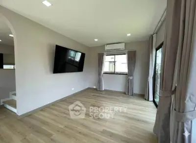 Spacious living room with modern decor and large windows for natural light.
