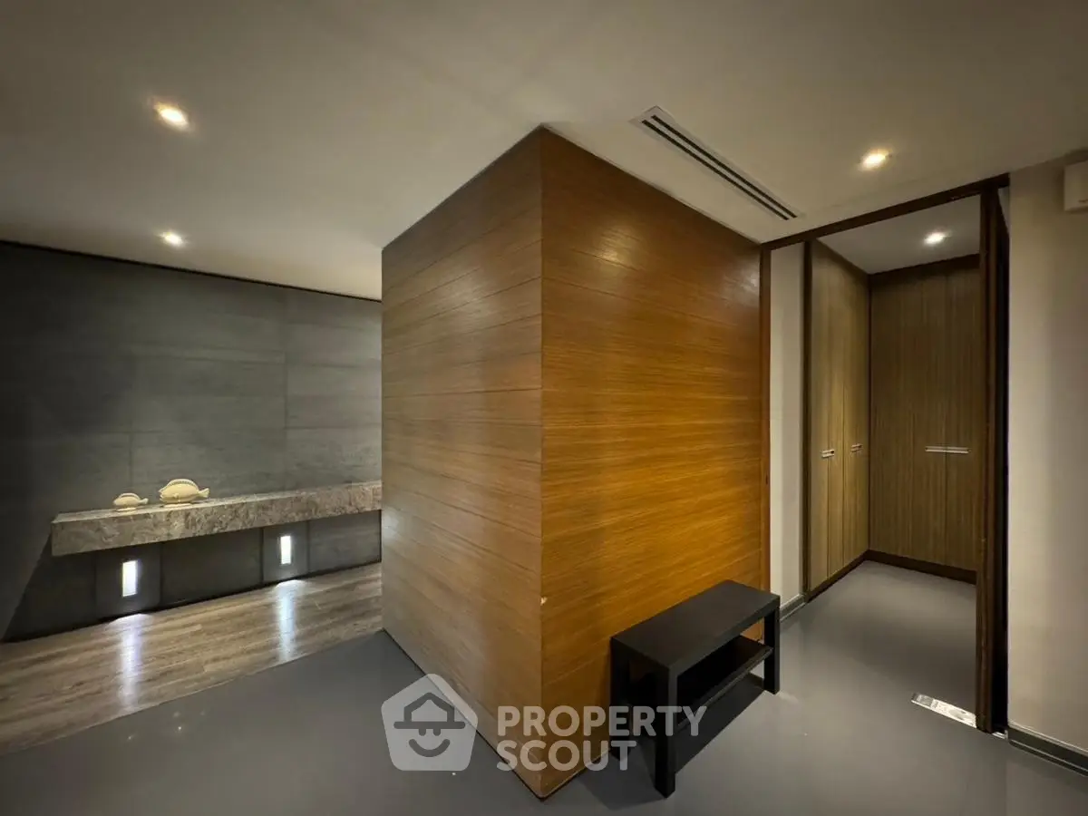 Modern interior with sleek wooden paneling and contemporary design elements.