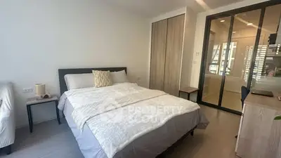 Modern bedroom with cozy bed and stylish decor in a bright apartment.