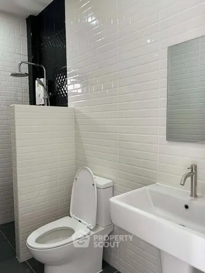 Modern bathroom with sleek white tiles and contemporary fixtures
