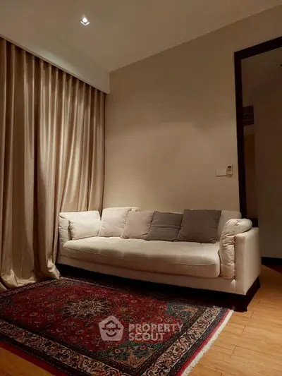 Cozy living room with elegant sofa and plush carpet, perfect for relaxation.