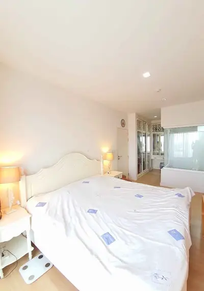 Bright and spacious bedroom with elegant decor and ample natural light.