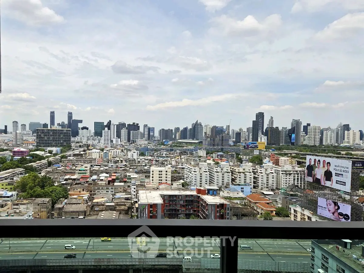 Stunning cityscape view from high-rise balcony overlooking urban skyline.
