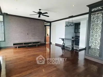 Spacious living room with hardwood floors and modern ceiling fan