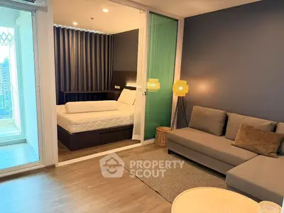 Modern studio apartment with cozy living area and balcony access.