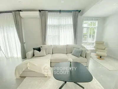 Bright and spacious living room with modern furniture and large windows