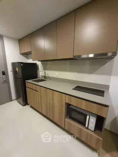 Modern kitchen with sleek cabinetry and built-in appliances in a stylish apartment.