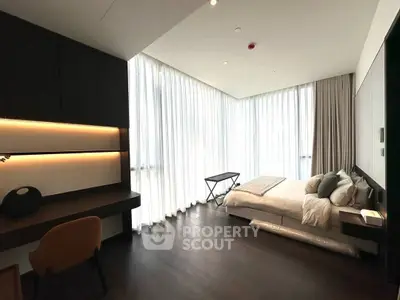 Luxurious modern bedroom with floor-to-ceiling windows and elegant furnishings.