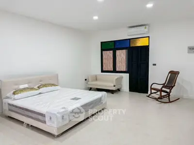 Spacious bedroom with modern furnishings and minimalist design