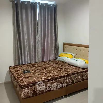 Cozy bedroom with elegant curtains and comfortable bed in modern apartment.