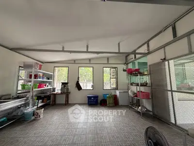 Spacious storage room with ample shelving and natural light, perfect for organizing and storing items efficiently.
