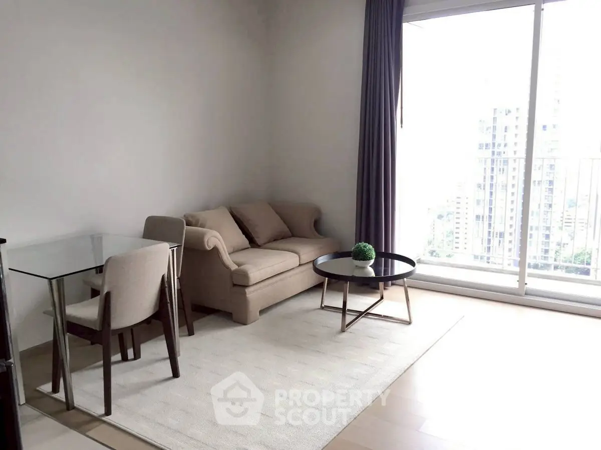 Bright modern living room with cozy sofa, glass dining table, and city view balcony.