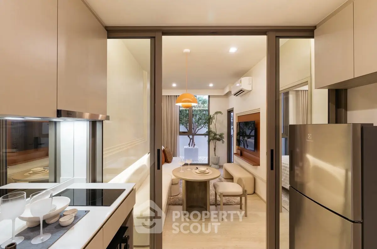 Modern kitchen with open layout leading to stylish dining area and cozy living room.
