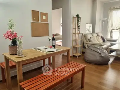 Charming open-plan living and dining area with cozy seating and natural light.