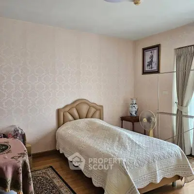 Cozy bedroom with elegant decor and soft lighting, featuring a plush bed and stylish furnishings.