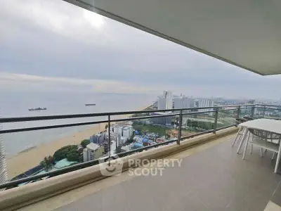 Stunning beachfront balcony with panoramic ocean views and modern outdoor seating.