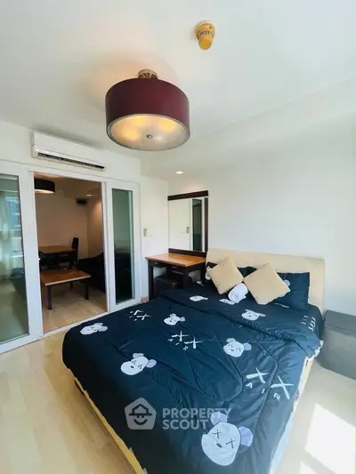Bright bedroom with modern decor and cozy bedding in stylish apartment.