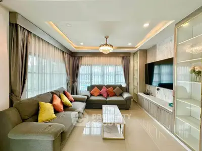 Spacious living room with modern decor and large windows for natural light.