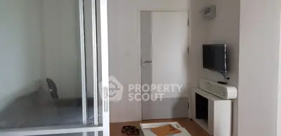 Modern apartment interior with sleek furniture and wall-mounted TV