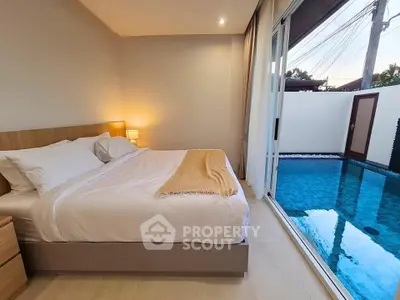 Luxurious bedroom with poolside view, featuring elegant decor and cozy ambiance for ultimate relaxation.