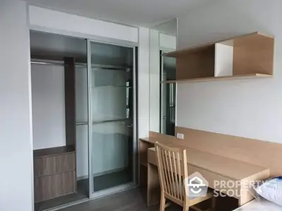 Modern study room with wooden desk, chair, and built-in closet in a stylish apartment.