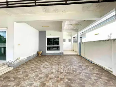 Spacious covered patio with tiled flooring and modern design, perfect for outdoor relaxation.