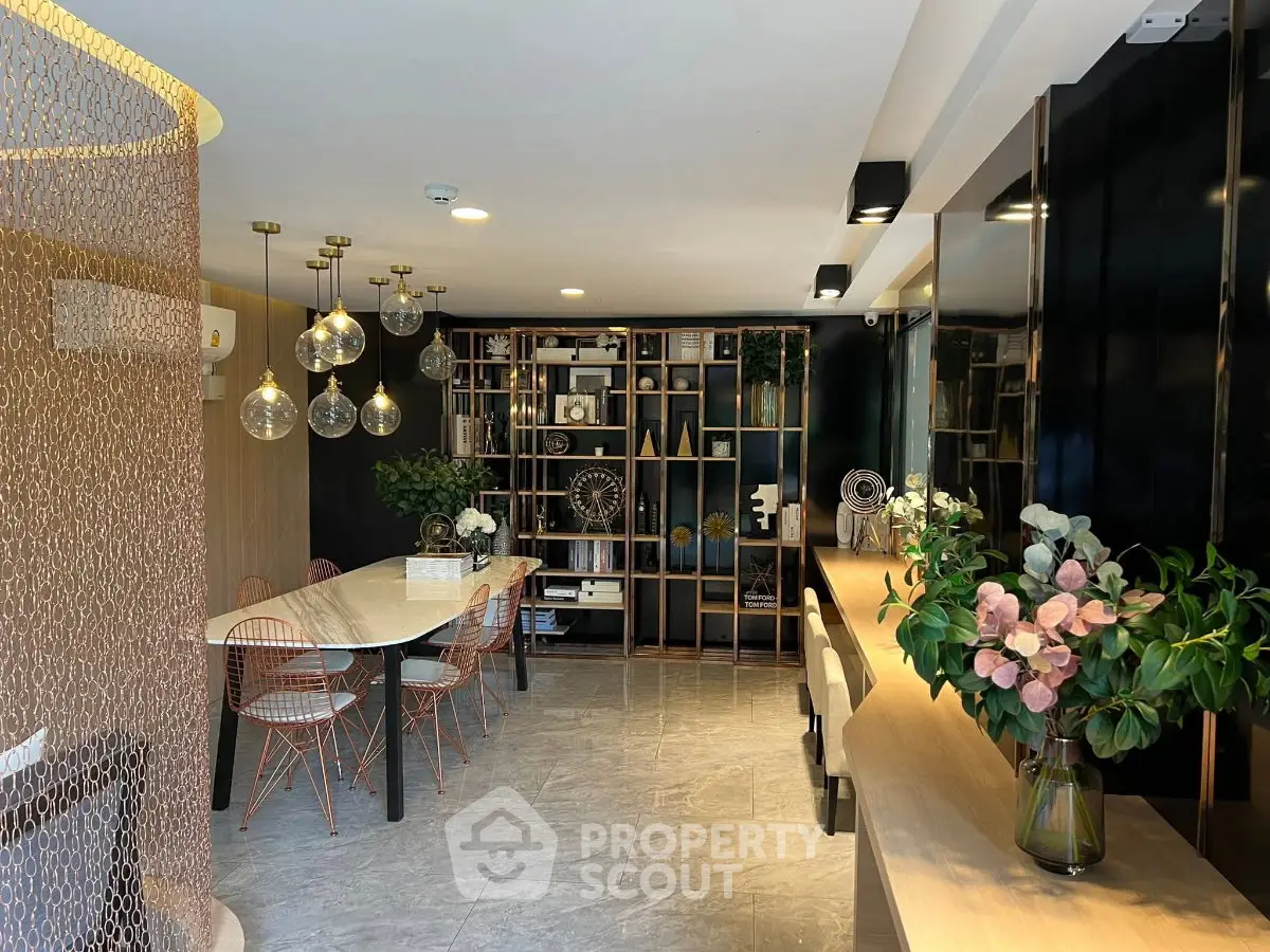 Stylish modern living room with elegant decor and open layout, featuring chic lighting and contemporary furniture.