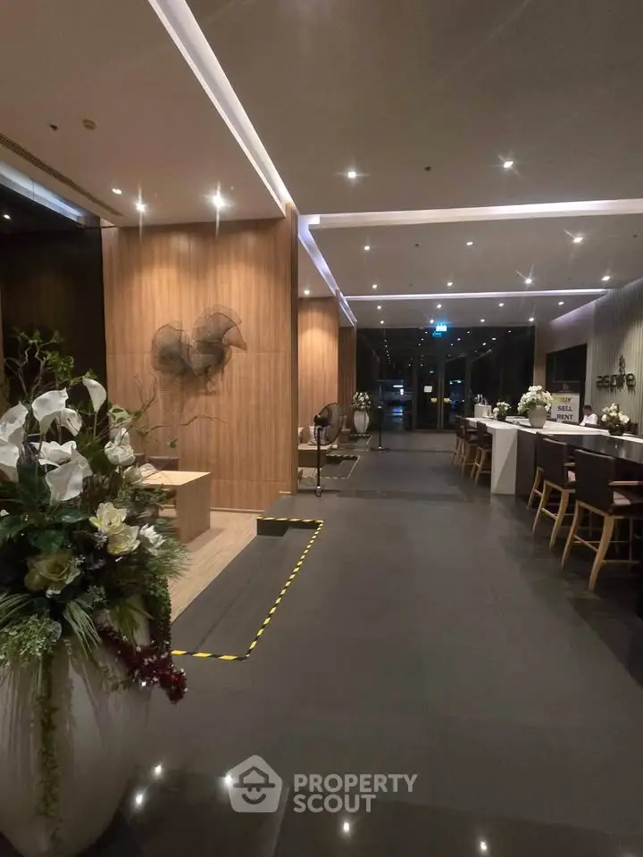 Luxurious modern lobby with elegant decor and ambient lighting in a high-end residential building.