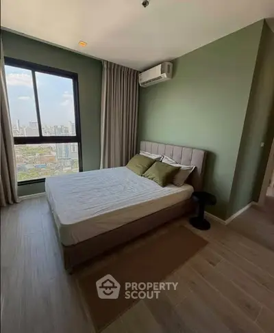 Modern bedroom with city view, featuring a cozy bed and air conditioning in a stylish apartment.