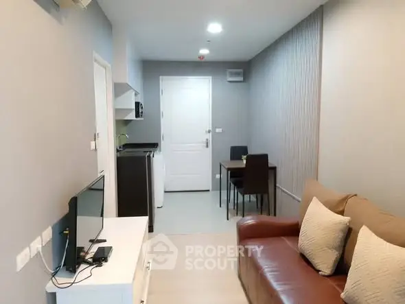 Modern living room with cozy sofa and dining area in a stylish apartment.