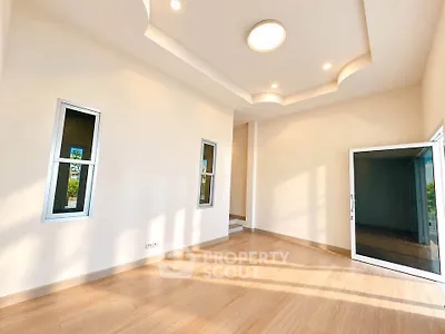 Spacious empty room with modern ceiling design and large windows