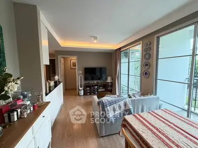 Modern living room with stylish decor and large windows offering natural light.