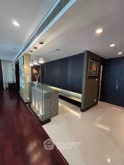 Luxurious modern interior with elegant lighting and dark wood flooring, perfect for sophisticated living.