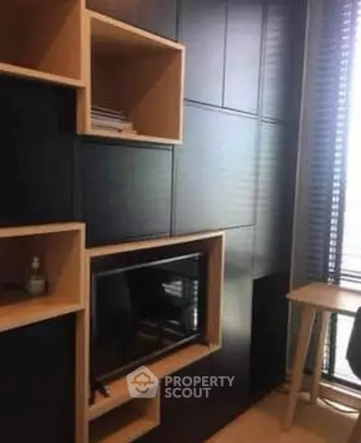 Modern study room with sleek black paneling and built-in shelving