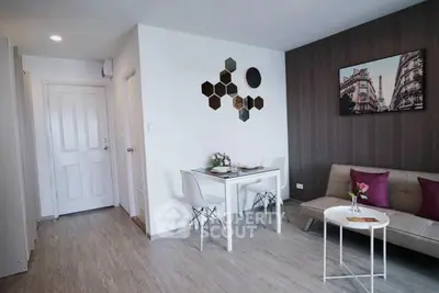 Modern living room with stylish decor and dining area in a cozy apartment.