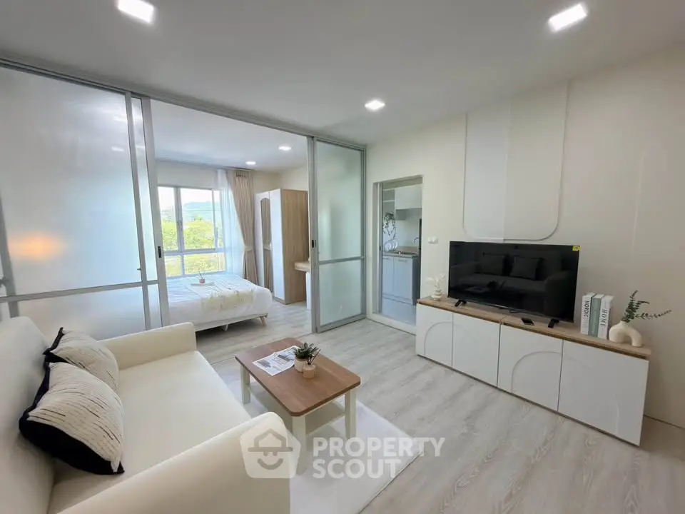Modern living room with sleek design and natural light, featuring a cozy sofa and stylish decor.