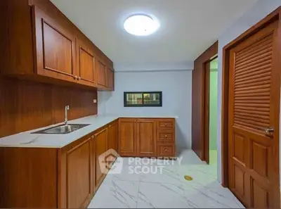Spacious kitchen with wooden cabinets and modern design