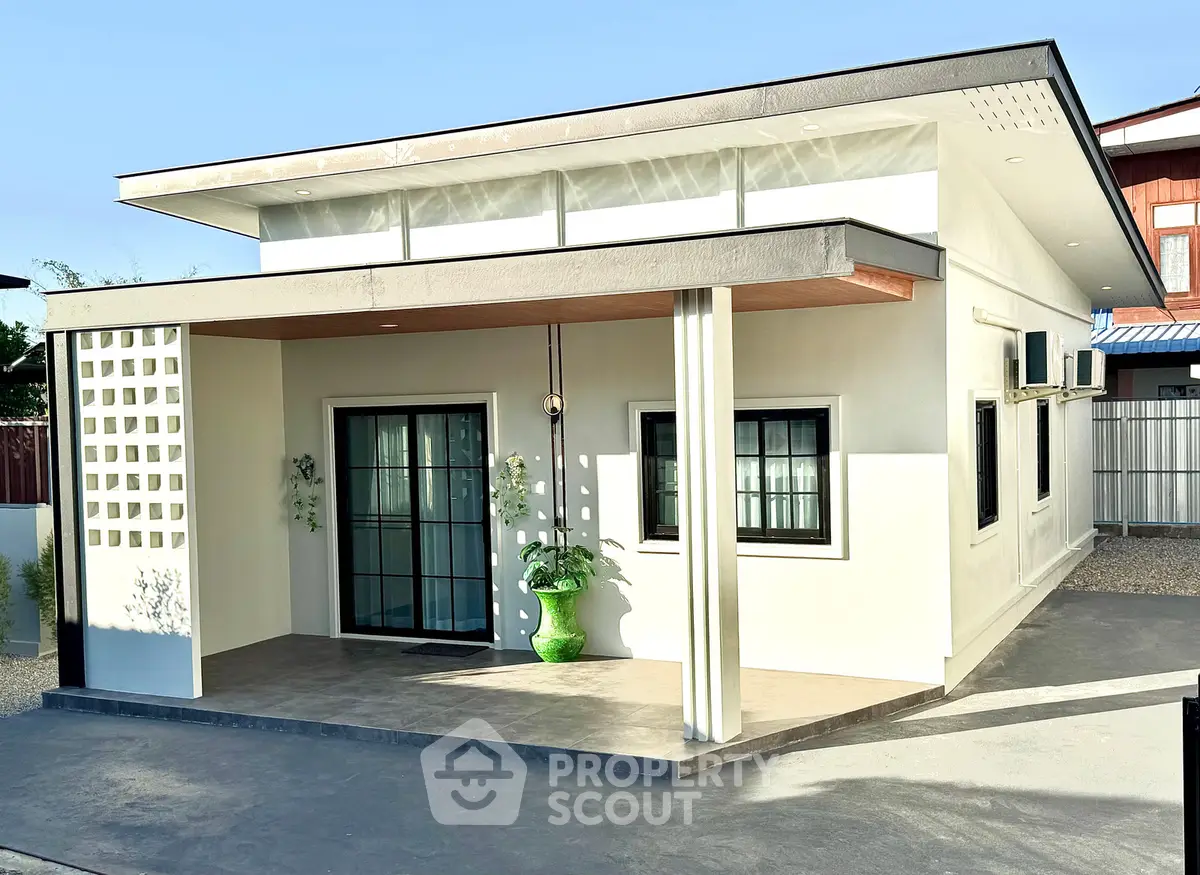 Modern single-story house with sleek design and large windows, perfect for contemporary living.