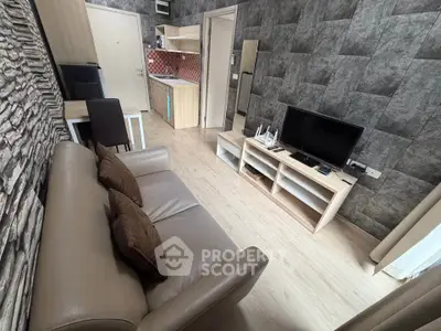 Modern living room with stylish decor and compact kitchen area, perfect for urban living.