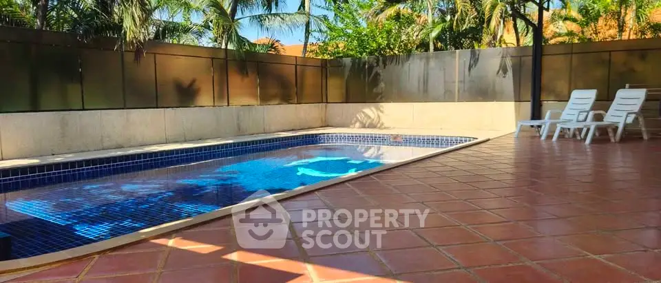 Luxurious private pool area with sun loungers and tropical landscaping, perfect for relaxation and entertainment.