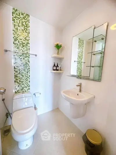 Modern bathroom with stylish green mosaic tiles and sleek fixtures
